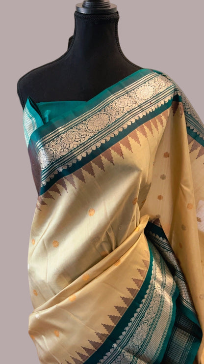 Saree with green and beige patterns on a mannequin against a neutral background